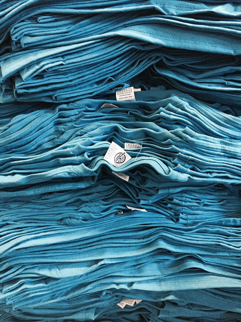 Stack of blue t-shirts - Marshall Atkinson
