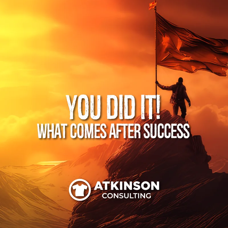 person planting a flag on the metaphorical success mountain.